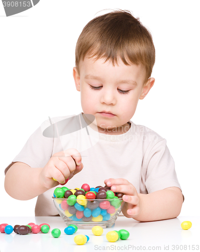 Image of Portrait of a boy with candies