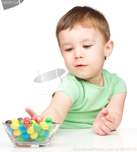 Image of Little boy refusing to eat candies