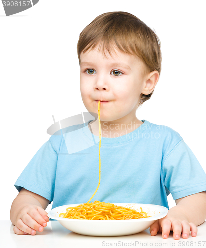 Image of Little boy is eating spaghetti