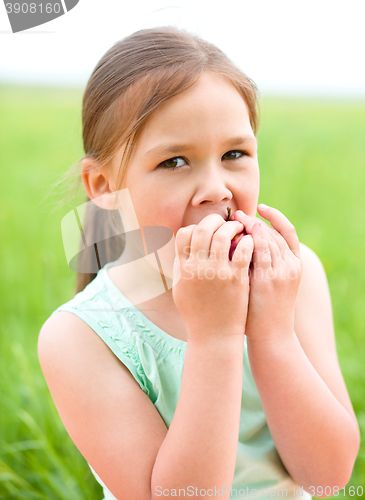 Image of Portrait of a little girl with apple