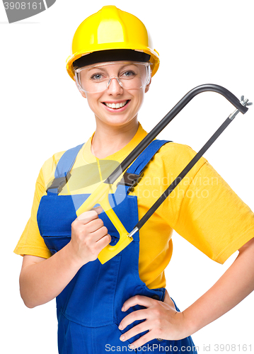 Image of Young construction worker with hacksaw