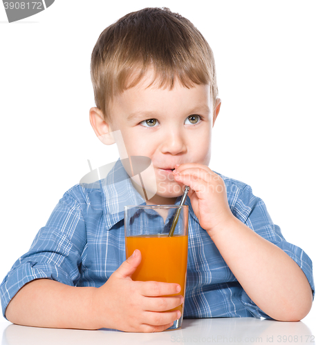 Image of Little boy with glass of carrot juice