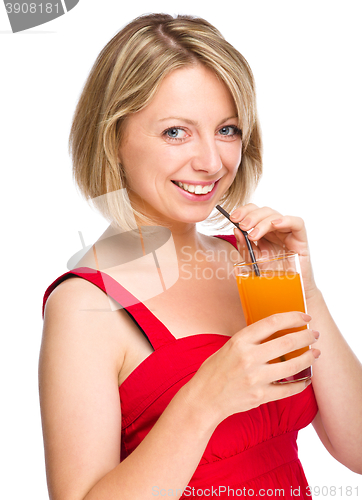 Image of Young woman is drinking carrot juice