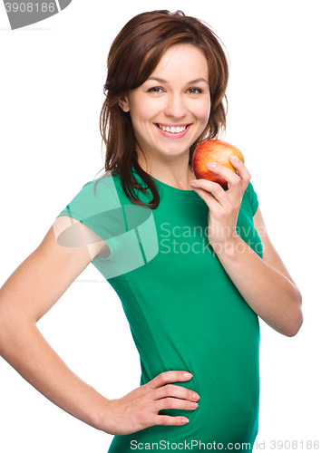 Image of Young happy girl with apple