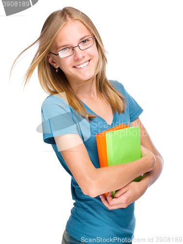 Image of Young student girl is holding book