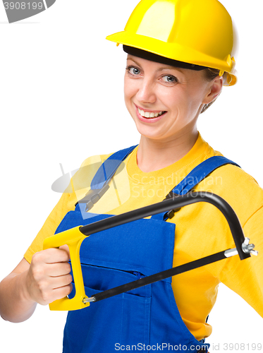 Image of Young construction worker with hacksaw