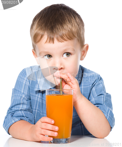 Image of Little boy with glass of carrot juice