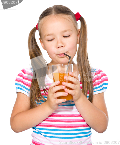 Image of Little girl is drinking carrot juice