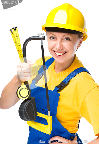 Image of Young construction worker with hacksaw