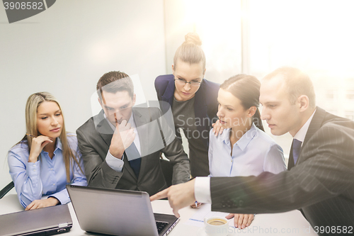 Image of business team with laptop having discussion