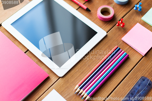 Image of close up of school supplies and tablet pc