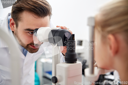 Image of optician with tonometer and patient at eye clinic