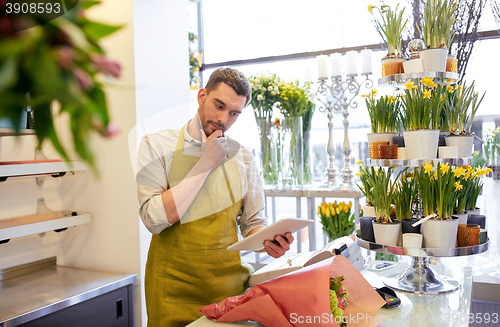 Image of man with tablet pc computer at flower shop