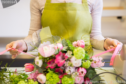 Image of close up of woman making bunch at flower shop