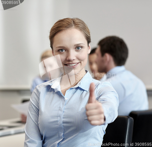 Image of group of smiling businesspeople meeting in office