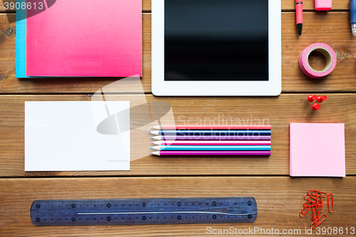 Image of close up of school supplies and tablet pc