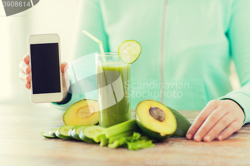 Image of close up of woman with smartphone and vegetables