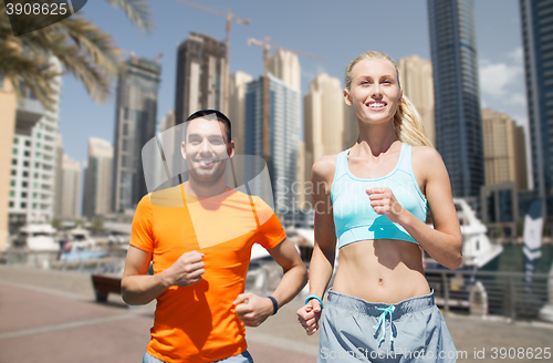 Image of couple running over dubai city street background