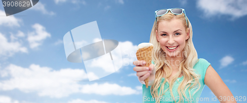 Image of happy young woman in sunglasses eating ice cream