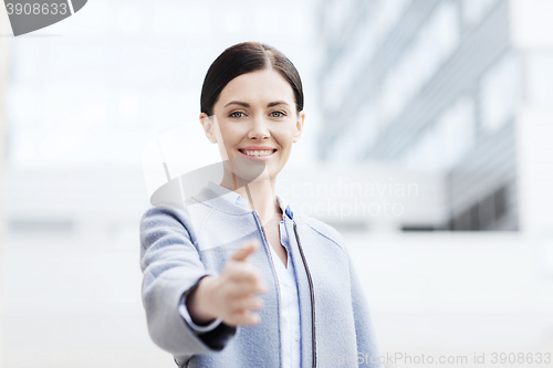 Image of smiling businesswoman giving hand for handshake