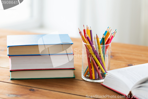 Image of close up of crayons or color pencils and books