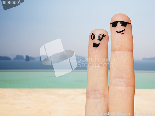 Image of close up of two fingers with smiley faces