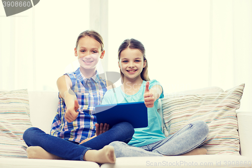 Image of happy girls with tablet pc and showing thumbs up