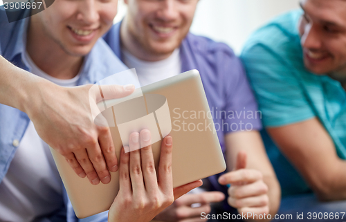 Image of close up of happy friends with tablet pc at home