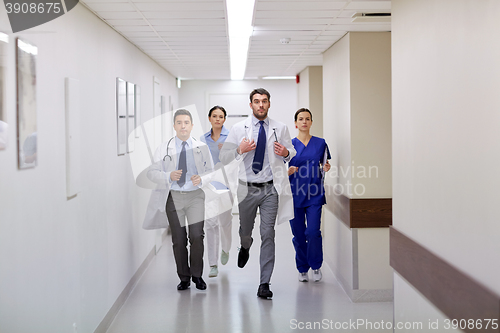 Image of group of medics walking along hospital