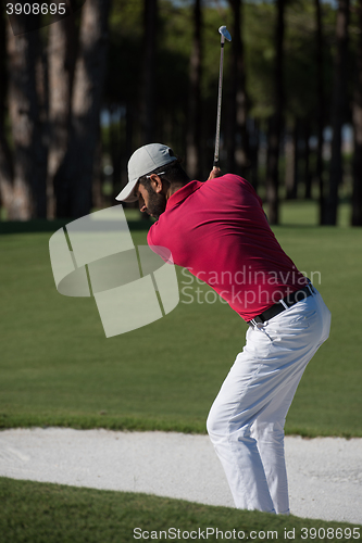 Image of golfer hitting a sand bunker shot