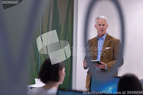 Image of teacher and students in computer lab classroom