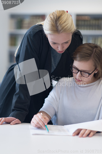 Image of female teacher helping students on class