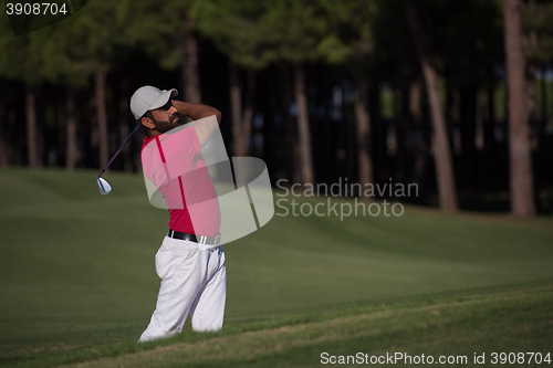 Image of golfer hitting a sand bunker shot
