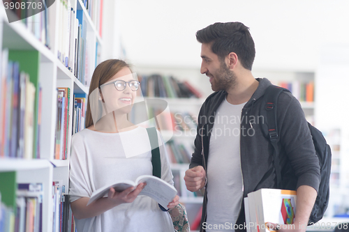 Image of students couple  in school  library