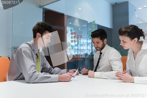 Image of young couple signing contract documents on partners back