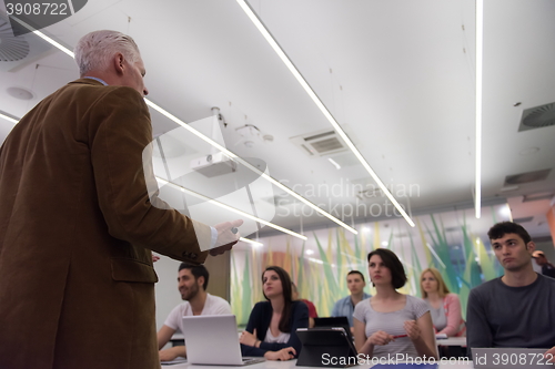 Image of teacher with a group of students in classroom