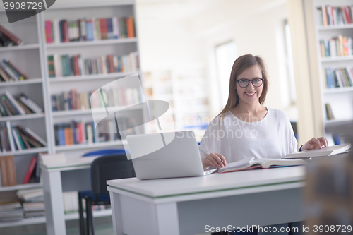 Image of female student study in school library