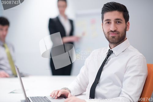 Image of young business man at meeting