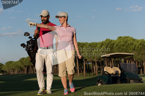 Image of couple walking on golf course