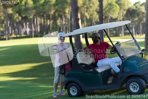 Image of couple in buggy on golf course