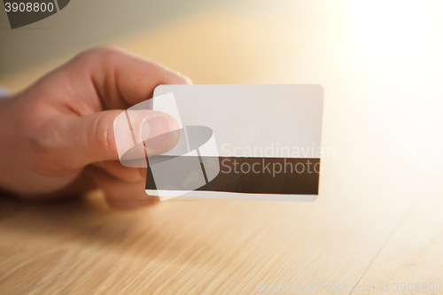 Image of The male hand showing credit card