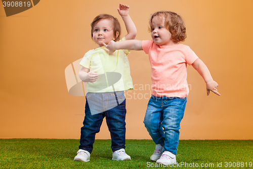 Image of Happy funny girl twins sisters playing and laughing