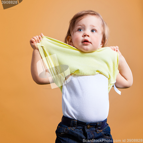 Image of One cute baby girl on orange background