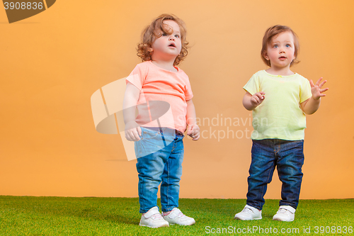 Image of Happy funny girl twins sisters playing and laughing