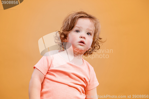 Image of One cute baby girl on orange background
