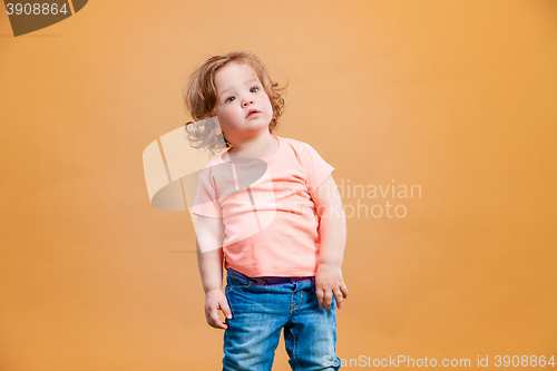 Image of One cute baby girl on orange background