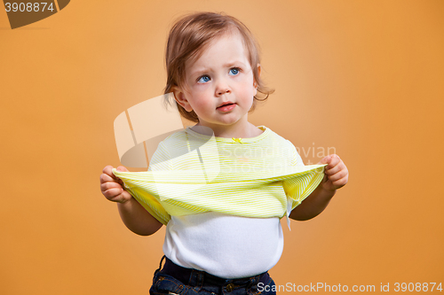 Image of One cute baby girl on orange background