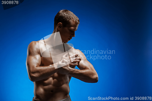 Image of Fit young man with beautiful torso on blue background