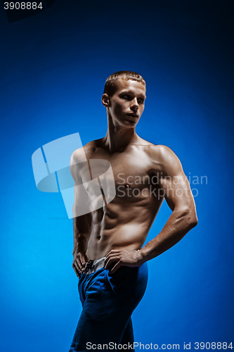 Image of Fit young man with beautiful torso on blue background