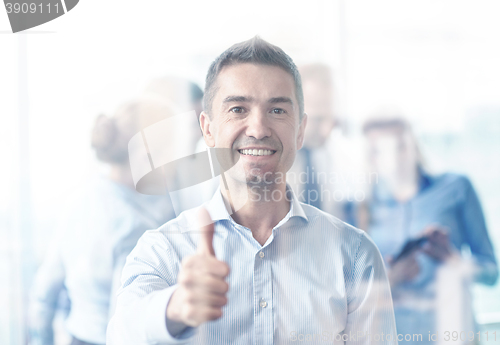 Image of group of smiling businesspeople meeting in office